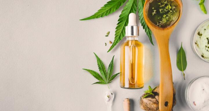 Hemp leaves and bottle of CBD oil