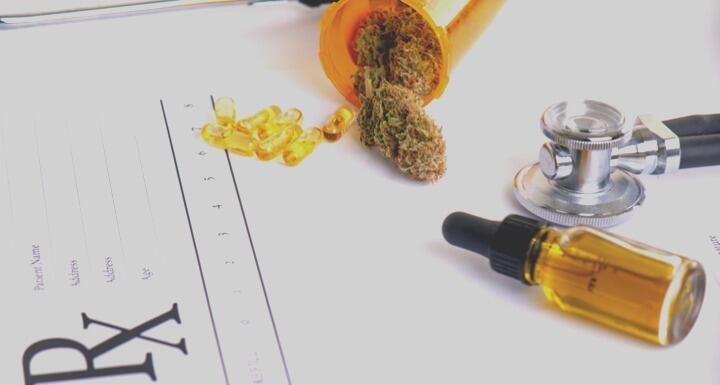 Cannabis products and CBD oil on top of blank prescription pad