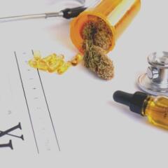 Cannabis products and CBD oil on top of blank prescription pad