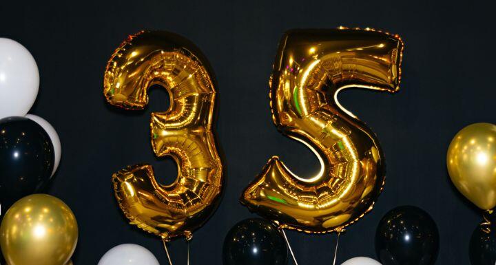 Celebrating 35 Years with Gold and Black Balloons