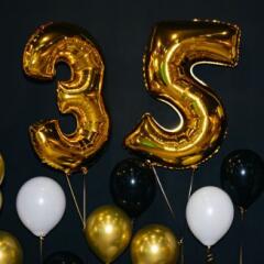 Celebrating 35 Years with Gold and Black Balloons