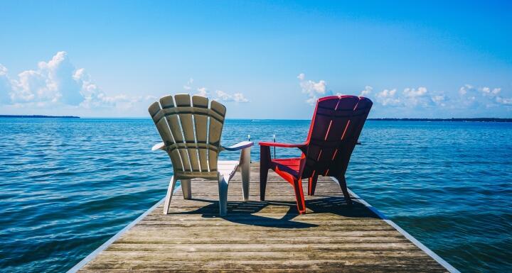 Red and white chairs on dock