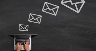 Chalk email icons with laptop on blackboard