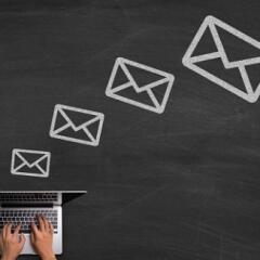 Chalk email icons with laptop on blackboard