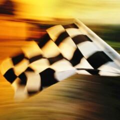 Checkered flag waving at an car race.