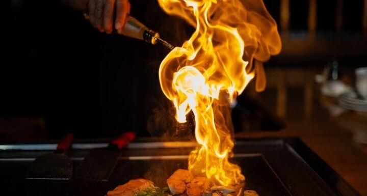 Chef cooking in Japanese teppanyaki restaurant