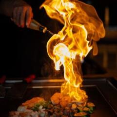 Chef cooking in Japanese teppanyaki restaurant