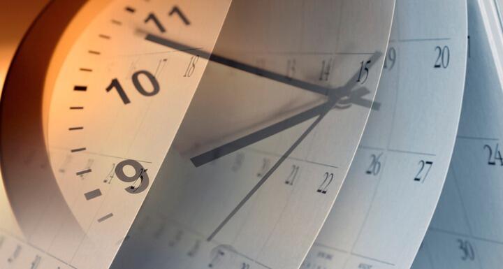 silhouette of a clock overlayed on a calendar