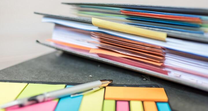 Colorful post it notes and files on a desk