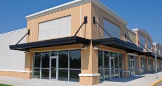 Tan and white commercial shopping building to illustrate commercial leases