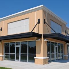 Tan and white commercial shopping building to illustrate commercial leases