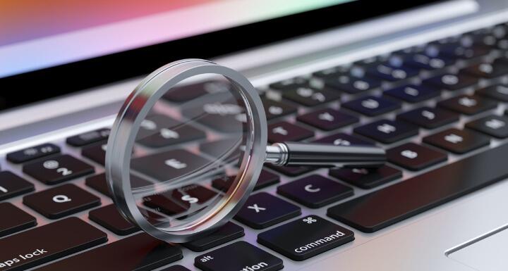 Magnifying glass on top of computer keyboard