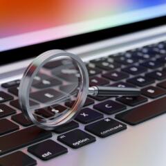Magnifying glass on top of computer keyboard