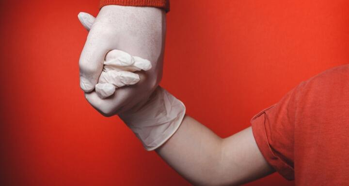 Dad and son holding gloved hands