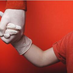 Dad and son holding gloved hands