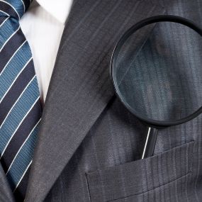 Magnifying glass in suit pocket