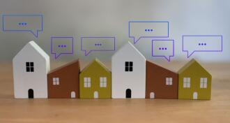 Different size of wooden toy house with speech bubble pop up