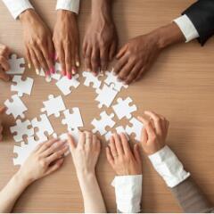 Diverse Group putting together a puzzle