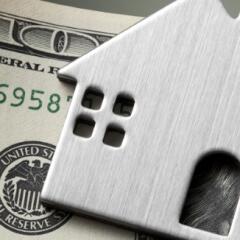 Dollar bills with miniature model house