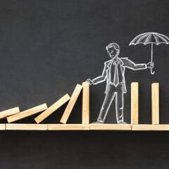 Domino Effect and Business Challenge Concept with Hand Drawn Chalk Illustrations on Blackboard