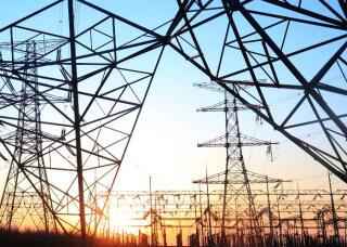 Electricity workers and pylon silhouette