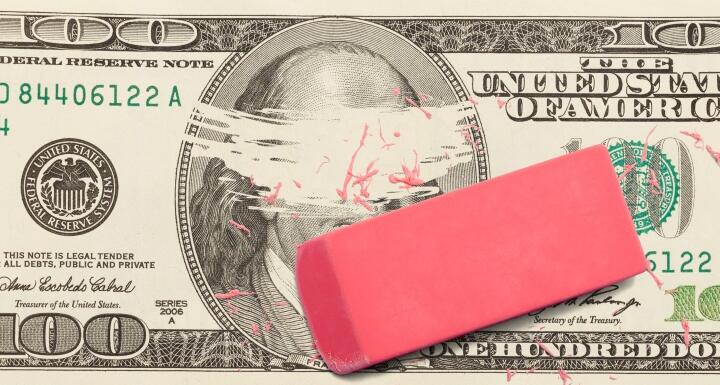 one hundred dollar bill with Ben Franklin's face erased by a pink eraser