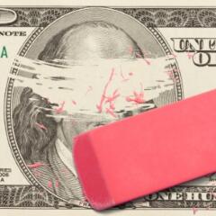 one hundred dollar bill with Ben Franklin's face erased by a pink eraser