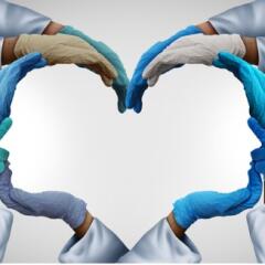 Hands in medical gloves form the silhouette of two people 