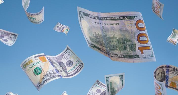 100 dollar bills falling from blue sky