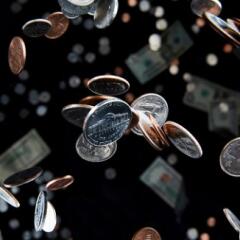 Several shiny falling coins tumbled about