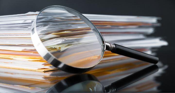 file stack and magnifying glass