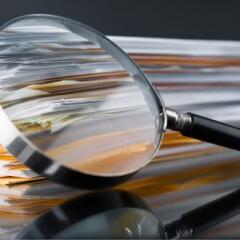 file stack and magnifying glass