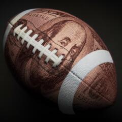 Football with image of 100 dollar bill superimposed