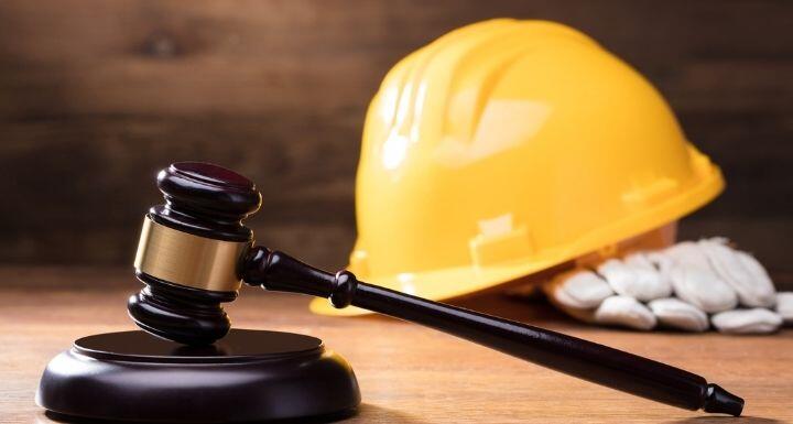 Gavel In Front Of Yellow Safety Helmet