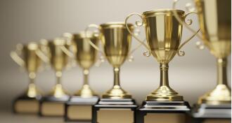 Goldend trophy cups on gray background