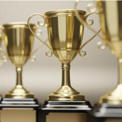 Goldend trophy cups on gray background