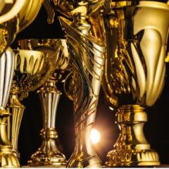 Golden trophies on black background