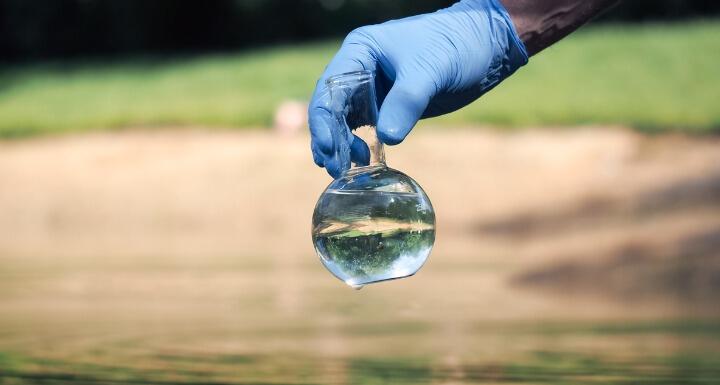 Hand holding retort with clear water