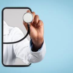 Hand of black woman doctor in white coat listen breath with stethoscope on smartphone-MAIN