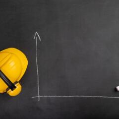 Hard hat on chalkboard with blank chart drawing