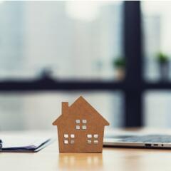 A toy home on top of a laptop computer