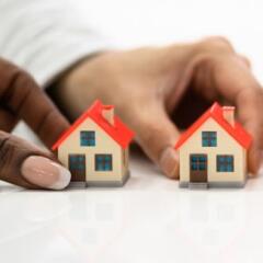 People Holding House Model On White Surface
