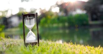 Hourglass on green grass