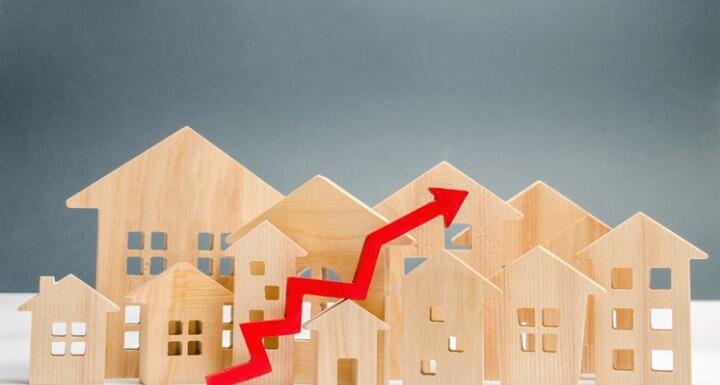 Multiple Wooden Home cutouts with red up arrow