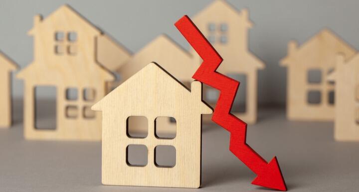 Wooden houses with red down arrow