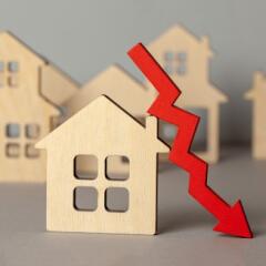 Wooden houses with red down arrow