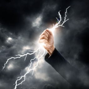 Hand grasping lightning bolt