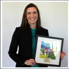 Jenny Boyer holding her Pro Bono Award