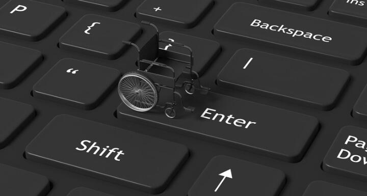 Black wheelchair on a black keyboard with white letters