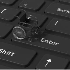 Black wheelchair on a black keyboard with white letters